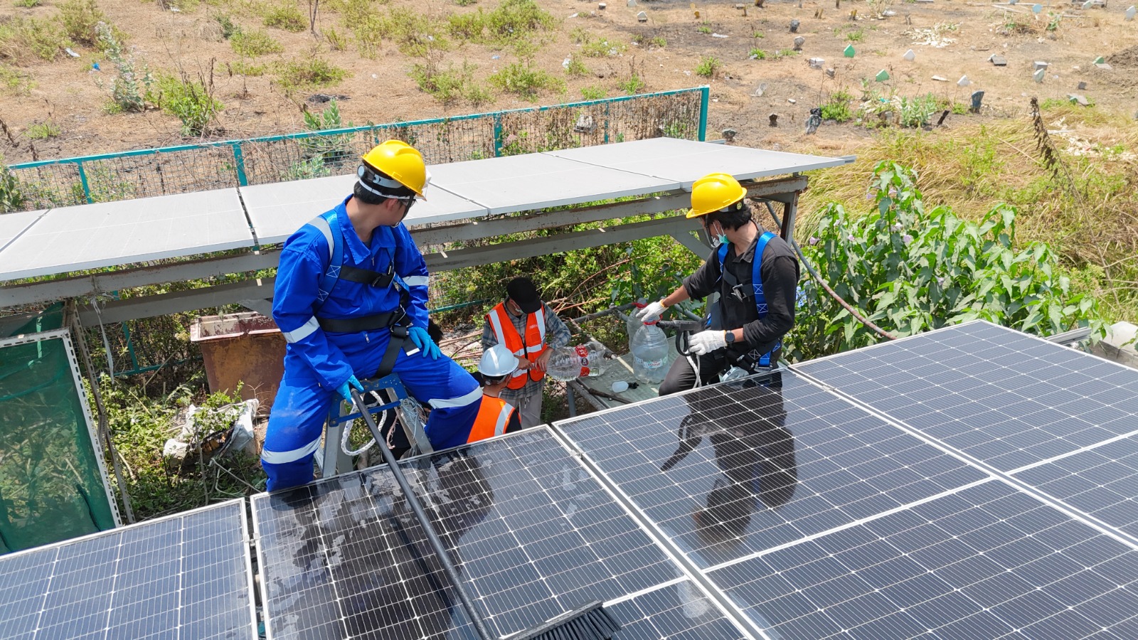 Technician manually cleaning solar panels